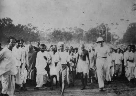 Gandhiji Marching through Satyabhamapur with Prof. Malkani and Piere Cersole during his Harijan movement tour in Orissa, 1934.jpg